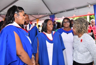 Minister of Education, Skills, Youth and Information, Senator Dr. the Hon. Dana Morris Dixon (right), in discussion with teachers during a graduation ceremony at the University of the West Indies (UWI) Mona Campus in St. Andrew on November 3.

