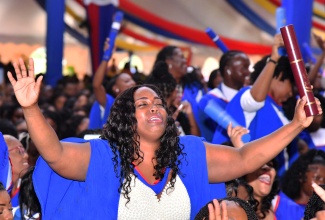 Early childhood educator, Rhonda Thompson (centre), celebrates during a graduation ceremony at the University of the West Indies (UWI) Mona Campus in St. Andrew on November 3.

