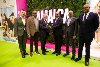 Minister of Tourism, Hon. Edmund Bartlett (3rd L) shakes hands with Mark Nueschen, World2Meet’s (W2M) International Business Manager, at the Jamaica booth at World Travel Market (WTM) London yesterday. Others are (L-R) Juan Romaguera, Head of Partnership Marketing, World2Meet;  Donovan White, Director of Tourism, Jamaica Tourist Board (JTB); Gregory Shervington, JTB’s Regional Director for Continental Europe and Delano Seiveright, Advisor and Senior Communications Strategist, Ministry of Tourism. This follows the announcement of a new flight from Portugal to Montego Bay with Spanish airline World2Fly. 