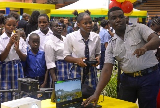 Jamaica Fire Brigade (JFB) Corporal, Garfield Nembhard, shows students of the Chetolah Mel Nathan Educational Centre how the JFB uses drone technology in its operations. The JFB was among the entities participating in the Ministry of Local Government and Community Development Local Government Expo, held on Wednesday (November 20) at the National Indoor Sports Centre in Kingston. The expo was among activities organised to commemorate Local Government and Community Month 2024 in November.

