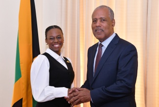 Chief Executive Officer of the Port Authority of Jamaica and Chairman of the Police Service Commission, Professor the Hon. Gordon Shirley (right), congratulates 2025 Rhodes Scholar, Aundrene Cameron, during the announcement ceremony on Thursday (November 14) at King’s House. Professor Shirley deputised for Governor-General, His Excellency the Most Hon. Sir Patrick Allen, as this year’s Rhodes Scholarship Selection Committee Chair.

