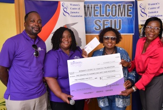 Minister of Culture, Gender, Entertainment and Sport, Hon. Olivia Grange (second right), and Executive Director of the Women’s Centre of Jamaica Foundation, Novelette Howell (right), accept a donation of just over $2.6 million from the Service Employees International Union (SEIU) Healthcare, in Canada, to support the Morant Bay Women’s Centre. Making the presentation on November 15 is Executive Board Member, SEIU, Gloria Turney. At left is SEIU Healthcare President, Tyler Downey.

