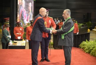 Governor-General, His Excellency the Most Hon. Sir Patrick Allen (left), presents the Order of Jamaica (OJ) to former Custos Rotulorum for Clarendon, William ‘Billy’ Shagoury, during the Ceremony of Investiture and Presentation of National Honours and Awards at the National Indoor Sports Centre on October 21.

