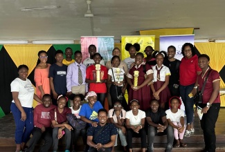 Members of the speech society of the Godfrey Stewart Performing Arts Society (GSPAS) display trophies won in the speech finals of the 2024 Jamaica Cultural Development Commission (JCDC) festival of the arts competitions.  

