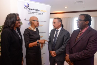 Financial Secretary in the Ministry of Finance and the Public Service, Darlene Morrison (left), participates in discussion with (from second left) Minister of Finance and the Public Service, Hon. Fayval Williams, and Tax Administration Jamaica (TAJ) Board Chair, Paul Lalor, and Commissioner General, Ainsley Powell, during the TAJ’s 10th anniversary tax forum on Wednesday (November 13), at the Jamaica Pegasus Hotel in New Kingston.

