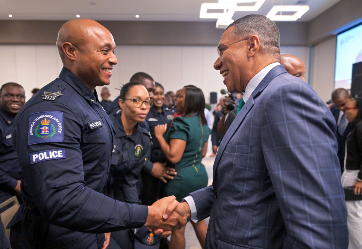 Prime Minister, Dr. the Most Hon. Andrew Holness (right), congratulates Sergeant Fitzroy Rochester during Tuesday’s (November 12) graduation ceremony for the second cohort of participants in the Jamaica Constabulary Force’s (JCF) Inspector Development Course, at the AC Hotel by Marriott Kingston. A total of 99 persons participated in the course.