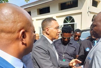 Prime Minister, Dr. the Most Hon Andrew Holness (second left), is greeted by a mourner when he arrived at the Thanksgiving Service for late educator and community stalwart, Carmelita Lawrence, at the Moving Church of God in Runaway Bay, St. Ann, on November 9.

