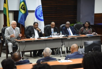Justice Minister, Hon. Delroy Chuck (left), addresses the CCJ Academy for Law regional townhall at the University of the West Indies, Mona Campus, St. Andrew, recently. The hybrid session focused on advancing justice in the Caribbean, post Needham’s Point Declaration. Listening (from second left) are: Senior Deputy Director of Public Prosecutions, Jeremy Taylor, KC; Attorney-at-law, Peter Champagnie, KC; Deputy Commissioner of Police, Richard Stewart, and Executive Director, Jamaicans for Justice, Mickel Jackson.

