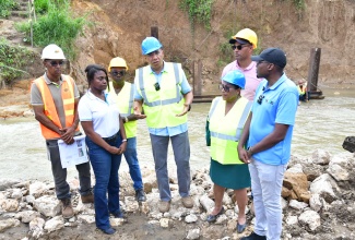 Prime Minister, Dr. the Most Hon. Andrew Holness (centre) makes a point during a tour of the Troy Bridge construction site in Trelawny on Friday (November 8). Others (from second left) are Permanent Secretary in the Ministry of Economic Growth and Job Creation, Arlene Williams; Member of Parliament for Northwest Manchester Mikael Phillips; former Member of Parliament for Southern Trelawny, Marisa Dalrymple-Philibert; and Minister without portfolio in the Ministry of Economic Growth and Job Creation with responsibility for Works, Hon. Robert Morgan.