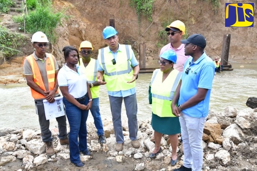 Prime Minister, Dr. the Most Hon. Andrew Holness (centre) makes a point during a tour of the Troy Bridge construction site in Trelawny on Friday (November 8). Others (from second left) are Permanent Secretary in the Ministry of Economic Growth and Job Creation, Arlene Williams; Member of Parliament for Northwest Manchester Mikael Phillips; former Member of Parliament for Southern Trelawny, Marisa Dalrymple-Philibert; and Minister without portfolio in the Ministry of Economic Growth and Job Creation with responsibility for Works, Hon. Robert Morgan.