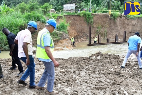 Prime Minister, Dr. the Most Hon. Andrew Holness (right) along with Senior Director at the National Works Agency (NWA), Varden Downer, tour the Troy Bridge construction site in Trelawny on Friday (November 8). The bridge which links several Trelawny, Manchester and St. Elizabeth communities collapsed in August 2021, during the passage of Tropical Storm Grace.
