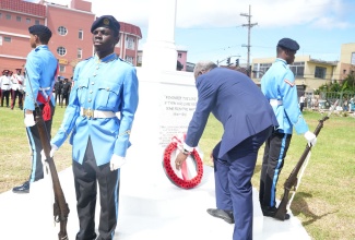 Custos Rotulorum for St. James, Bishop the Hon. Conrad Pitkin, lays a wreath at the Cenotaph on the grounds of the St. James Parish Church in Montego Bay during Monday’s (November 11) Remembrance Day ceremony. Flanking the monument are members of the Jamaica Combined Cadet Force (JCCF). 