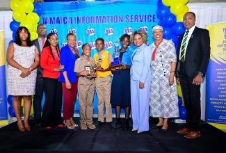 Minister of Education, Skills, Youth and Information, Senator Dr. the Hon. Dana Morris Dixon (third right), joins the Jamaica Information Service (JIS) executive management team led by Chief Executive Officer, Enthrose Campbell (fourth left); JIS Advisory Board Chair, Kimberley McLeod (left); and Keynote Speaker, Dr. Amina Blackwood Meeks (second right), in congratulating the top performers in the essay category of the JIS Heritage competition, during Tuesday`s (December 10) awards ceremony held at the Terra Nova All-Suite Hotel in Kingston. The students are Jonathan Clark (fifth left) from Stella Maris Preparatory in St. Andrew, who placed third; Oshane Morris (fifth right) from Snowdon Primary School in Manchester, who placed second; and winner, Kamili Forrester from Goshen Primary School in St. Elizabeth. The JIS team members (from left) are Director, Corporate Services, Errol Gardner; Acting Director, Research, Print and Production, Andrine Davidson; and Director of Human Resources, Dr. David Knight.

