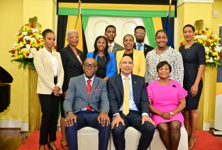 Governor-General, His Excellency the Most Hon. Sir Patrick Allen (front row, centre); Her Excellency, the Most Hon. Lady Allen (front row, left), and Custos of St. Andrew, Hon. Ian Forbes (front row, right), share a photo opportunity with ambassadors of the ‘I Believe Initiative’ (IBI), who hail from St. Andrew, during Thursday’s (Dec. 12) induction ceremony at King’s House in Kingston.  