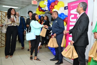 Mayor of Kingston, Councillor Andrew Swaby (second right) along with Deputy Director of Tourism, Marketing, Peter Mullings (right) welcome passengers arriving on the inaugural flight for LIAT20 Airlines out of Antigua to Norman Manley International Airport (NMIA) in Kingston on December 20. 