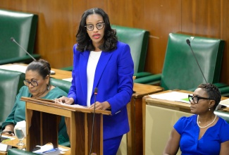 Member of Parliament for Manchester Central, Rhoda Moy Crawford, makes her contribution to the State of the Constituency Debate in the House of Representatives, on Tuesday (December 10). Others present are (from left) Member of Parliament for Trelawny Southern, Marisa Dalrymple-Philibert and Member of Parliament for St. Andrew West Rural, Hon. Juliet Cuthbert-Flynn.