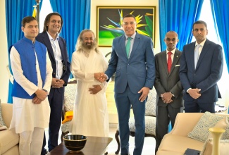 Prime Minister, Dr. the Most Hon. Andrew Holness (third right), shakes the hand of internationally revered spiritual leader, humanitarian, and Peace Ambassador, Gurudev Sri Sri Ravi Shankar (third left), during a meeting at Jamaica House on December 13. Sharing the moment (from left) are Bhushan Deodhar who is Mr. Gurudev’s Secretary for the United States; Founder and Chief Executive Officer of the Amber Group, Ambassador and Special Investment Envoy for Technology, Dushyant Savadia; Permanent Secretary in the Office of the Prime Minister, Ambassador Rocky Meade; and Senior Advisor/Consultant, Office of the Prime Minister of Jamaica, Alok Jain.

