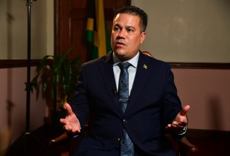 Minister without Portfolio in the Ministry of Economic Growth and Job Creation, Hon. Matthew Samuda, speaking during an interview with JIS News at his New Kingston office on Tuesday (November 26). 