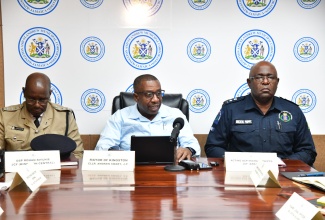 Mayor of Kingston, Councillor Andrew Swaby (centre), addresses a press conference at the Kingston and St. Andrew Municipal Corporation’s Church Street offices in downtown Kingston, on December 5. Listening (from left) are Deputy Superintendent in charge of operations, Kingston Central, Rohan Ritchie and Acting Assistant Commissioner of Police in charge of Area 4, Michael Phipps.

