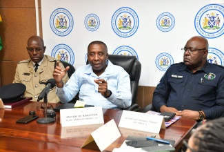 Mayor of Kingston, Councillor Andrew Swaby (centre), addresses a press conference at the Kingston and St. Andrew Municipal Corporation in downtown Kingston, on December 5. Listening (from left) are Deputy Superintendent of Police in charge of operations, Kingston Central, Rohan Ritchie, and Acting Assistant Commissioner of Police in charge of Area 4, Michael Phipps.

