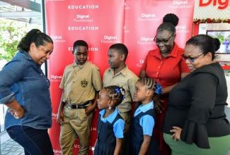 Chief Executive Officer of the Digicel Foundation, Charmaine Daniels (left), interacts with Principals and students during the organisation’s 20-for-20-for-20 Build Jamaica Grants handover ceremony on December 6. The event was held at Digicel’s headquarters in Kingston. From right are Principal of Salt Spring Primary and Infant School, Norma Brydson, and Principal of Prickly Pole Primary and Infant School, Judith Whyte Gayle. The students are Rickayla Warlock and Ty