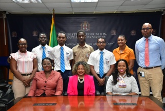 Minister of Education, Skills, Youth and Information, Senator Hon. Dr. Dana Morris Dixon (seated centre); Acting Chief Education Officer in the Ministry, Dr. Terry Ann Thomas Gayle (seated left); and Permanent Secretary in the Ministry, Dr. Kasan Troupe (seated right) share a photo opportunity with the St. George’s College team, which won the finals of the sixth annual Mathematics Quiz Competition organised by the University of Technology (UTech), Jamaica. Occasion was a courtesy call at the Ministry’s Heroes Circle offices in Kingston on December 12. Members of the St. George’s College teaching staff also shared in the occasion.

 