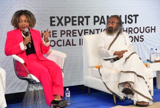 Minister of Education, Skills, Youth and Information, Senator Dr. the Hon. Dana Morris Dixon,  participates in a panel discussion on the topic: ‘Reshaping Tomorrow: Crime Prevention Through Social Intervention,’ on Thursday (Dec. 12), at The Summit Kingston. Looking on is revered spiritual leader, humanitarian, peace ambassador and Founder of Art of Living Foundation, Gurudev Sri Sri Ravi Shankar.

