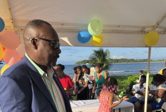 Mayor of Port Antonio, Councillor Paul Thompson, hands out meals during his annual children