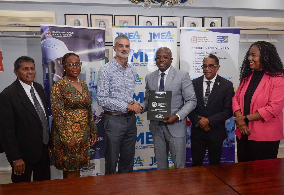 Minister of Labour and Social Security, Hon. Pearnel Charles Jr. (third right), displays the signed Memorandum of Understanding (MOU) with President of the Jamaica Manufacturers and Exporters Association (JMEA), Sydney Thwaites (third left)), to formalise the long-standing partnership between the Jamaica Productivity Centre (JPC) and the JMEA. They are joined by (from left) Board Member of the JPC, Reginald Budhan; Executive Director at the JMEA, Kamesha Turner-Blake; Minister of State in the Ministry of Labour and Social Security, Dr. the Hon. Norman Dunn and Chief Executive Officer (CEO) of the JPC, Tamar Nelson. The signing ceremony took place on Tuesday (December 10) at the Private Sector Organisation of Jamaica (PSOJ) Boardroom, 39 Old Hope Road in Kingston.