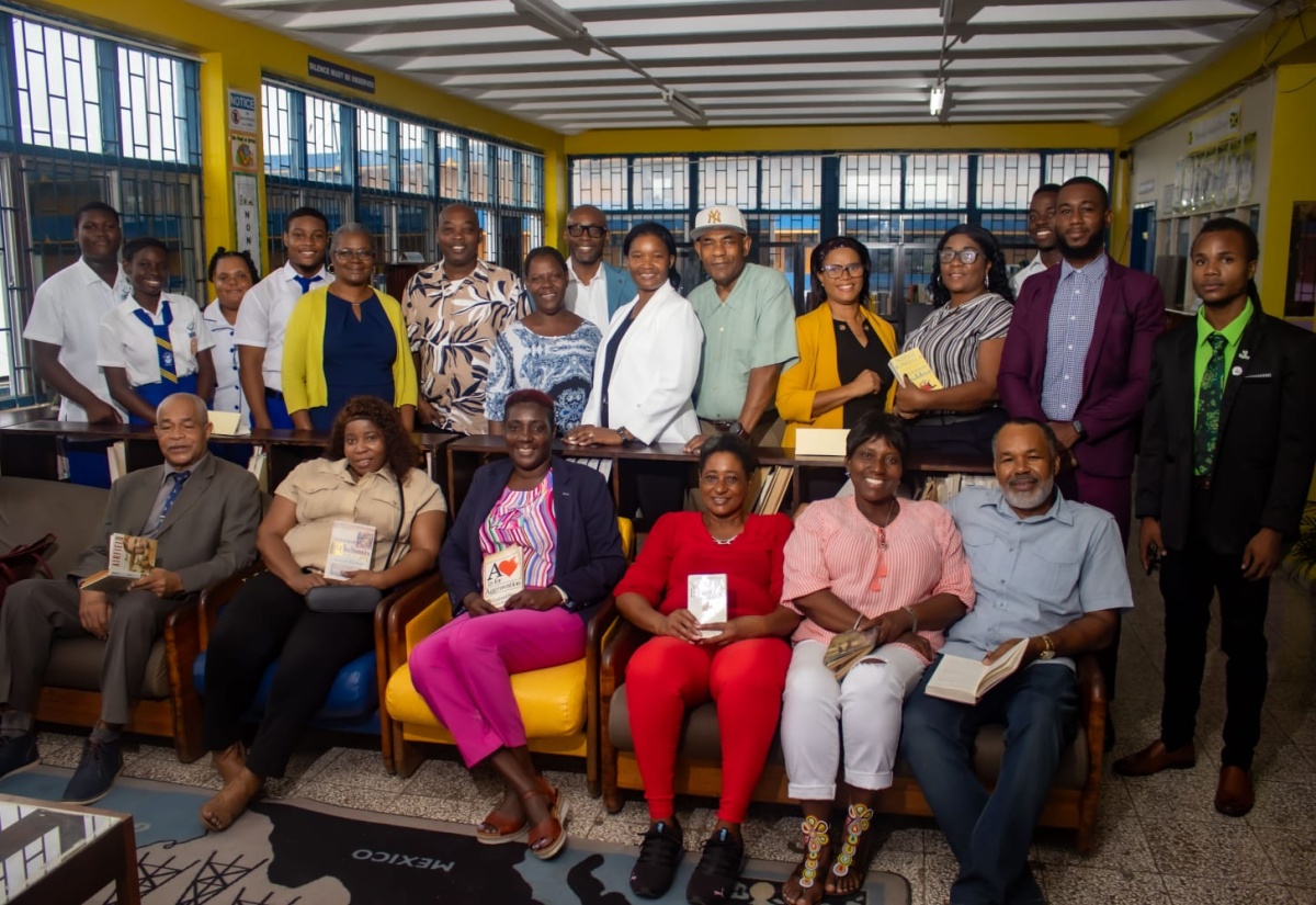 Regional Director with the Jamaica Library Service, Carrol Plummer (fifth left, standing), poses with staff, and current and past students of José Martí Technical High School in St. Catherine, during the recent handover of a $2.9-million upgraded library to the institution. The project was spearheaded by the José Martí Alumni Association New York Inc. (JMAANY), with support from various groups in the past-students association.

