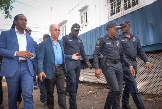 National Security Minister, Hon. Dr. Horace Chang (second left), tours sections of the Gregory Park community in Portmore, St. Catherine, during a visit to the Gregory Park Mobile Command on Wednesday (December 4). He is accompanied by (from left) Member of Parliament for St. Catherine East Central, Hon. Alando Terrelonge; Head of Strategic Operations, Acting Deputy Commissioner of Police, Warren Clarke; Acting Assistant Commissioner of Police, Christopher Phillips; and Deputy Superintendent of Police, St. Catherine South Division, Michael Campbell.

