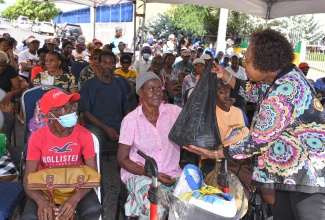 Minister of Culture, Gender, Entertainment and Sport, and Member of Parliament for St. Catherine Central, Hon. Olivia Grange, distributes care packages to senior citizens during the annual Christmas treat hosted by the Houses of Parliament on Wednesday (December 18). The event was held on the grounds of Gordon House in Kingston.


