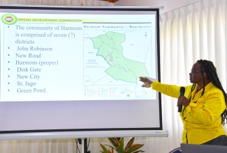 Research Coordinator with the Social Development Commission (SDC), Mrs. Stephanie Lewis Brown, points out key areas of the Harmons Valley development area during the Harmons Valley Water Project symposium held recently at Tropics View Hotel in Mandeville, Manchester.