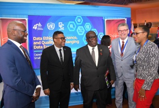 Statistical Institute of Jamaica (STATIN) Chairman, Robert Stennett (left), and Director General (Acting), Leesha Delatie-Budair (right), converse with (from second left): Director, Regional Statistics, CARICOM Secretariat, Halim Brizan; Resident Coordinator, United Nations (UN) Mission in Jamaica, Dennis Zulu, and Inter-Regional Adviser at the United Nations Statistics Division, Gabriel Gamez, during STATIN’s Capacity-Building Workshop focused on Data Ethics, Governance, and Quality for the Caribbean Small Island Developing States (SIDS) on Monday (December 2) at the Jamaica Conference Centre in downtown Kingston.