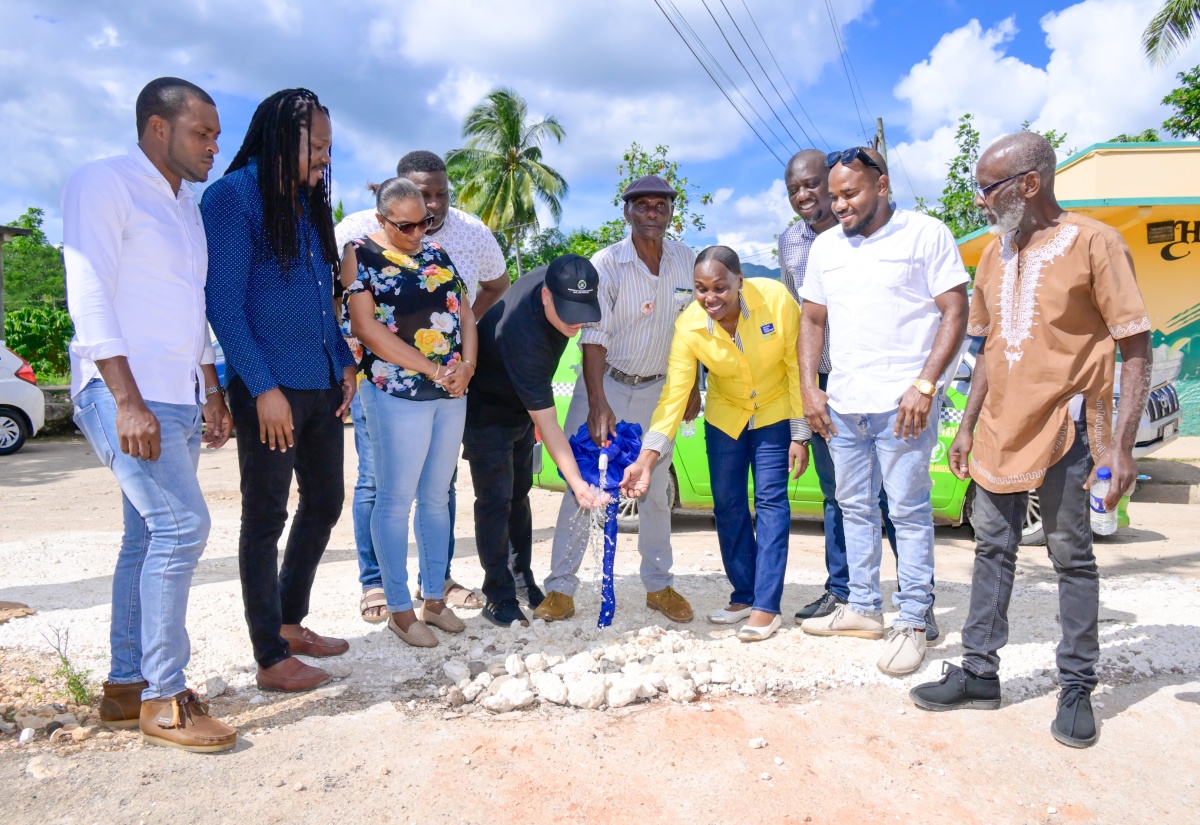 Minister without portfolio in the Ministry of Economic Growth and Job Creation, Hon. Matthew Samuda (fifth left), Senator Damion Crawford (second left), and other representatives from the community and the National Water Commission (NWC), participate in the commissioning of the $10.8 million Orangefield Water Improvement Project, on December 20, in St. Catherine.