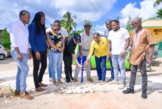 Minister without portfolio in the Ministry of Economic Growth and Job Creation, Hon. Matthew Samuda (fifth left), Senator Damion Crawford (second left), and other representatives from the community and the National Water Commission (NWC), participate in the commissioning of the $10.8 million Orangefield Water Improvement Project, on December 20, in St. Catherine.