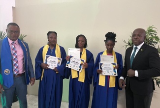 Minister of Labour and Social Security, Hon. Pearnel Charles Jr. (right), with Managing Director, Central Jamaica Social Development Initiative (CJSDI), Damion Young (left) and three graduates of the CJSDI’s training programme in Hospitality and Entrepreneurship. They are (from second left)  Diana Williams, Hannaree Edwards and Odette Cotterell.  Occasion was a graduation ceremony  held on December 1 at the Golf View Hotel in Mandeville, Manchester, for participants in the six-month programme. 