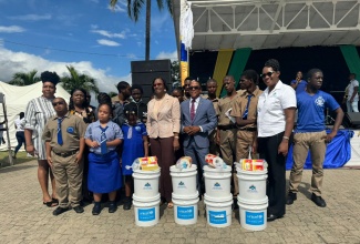 State Minister in the Ministry of Labour and Social Security, Dr. the Hon. Norman Dunn, (fourth right, front row); Acting Permanent Secretary in the Ministry, Dione Jennings (fourth left, front row), along with Executive Director of the Jamaica Council for Persons with Disabilities, Dr. Christine Hendricks (left, front row), pose with students and their teacher. The occasion was the recent launch of the ‘I Am Able’ Initiative by Dr. Dunn at the Police Officers Club in Kingston.

