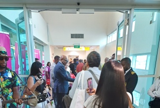 Passengers arrive from Lima, Peru, on a LATAM flight at the Sangster International Airport, Montego Bay, St. James, on December 1. They are being greeted by Tourism Minister, Hon Edmund Bartlett (at left).