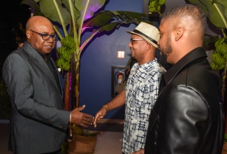 Minister of Tourism, Hon Edmund Bartlett, greet co-founders of TechBeach, Jamaican Kirk Hamilton (centre) and Trinidadian, Kyle Maloney (right), during the staging of the event at Secret Resorts in Montego Bay on Wednesday (December 4).

