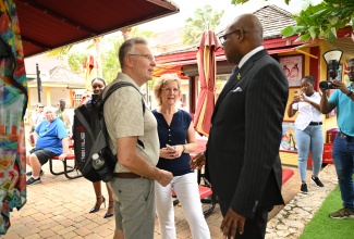 Minister of Tourism, Hon. Edmund Bartlett, interacting with visitors in Falmouth, Trelawny, prior to the start of the winter tourist season.