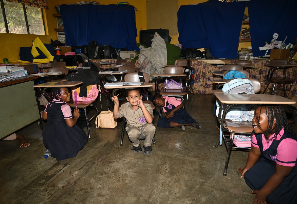 Students of Schoolfield Primary and Infant School in St. Elizabeth engage in the ‘drop, cover, and hold on’ technique during an earthquake drill on Wednesday, January 15.