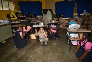 Students of Schoolfield Primary and Infant School in St. Elizabeth engage in the ‘drop, cover, and hold on’ technique during an earthquake drill on Wednesday, January 15.