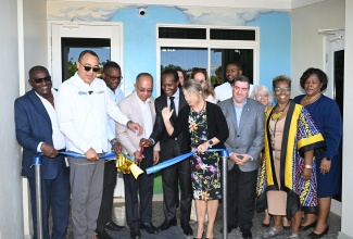 Deputy Prime Minister and Minister of National Security, Dr. Horace Chang (fourth left), cuts the ribbon to officially open the St. James Child and Adolescent Wellness Centre, at the renovated Corinaldi Avenue Primary School Teachers’ Cottage at 1 Humber Avenue, Montego Bay, St. James, on January 16. He is joined by (from left) Parish Manager, St James Health Services, Lennox Wallace; Health and Wellness Minister, Dr. the Hon. Christopher Tufton; Deputy Speaker of the House and Member of Parliament for St. James Central, Heroy Clarke;  Minister of State in the Ministry of Foreign Affairs and Foreign Trade, Hon. Alando Terrelonge; EU Ambassador to Jamaica, Her Excellency Dr. Erja Askola and other dignitaries.

