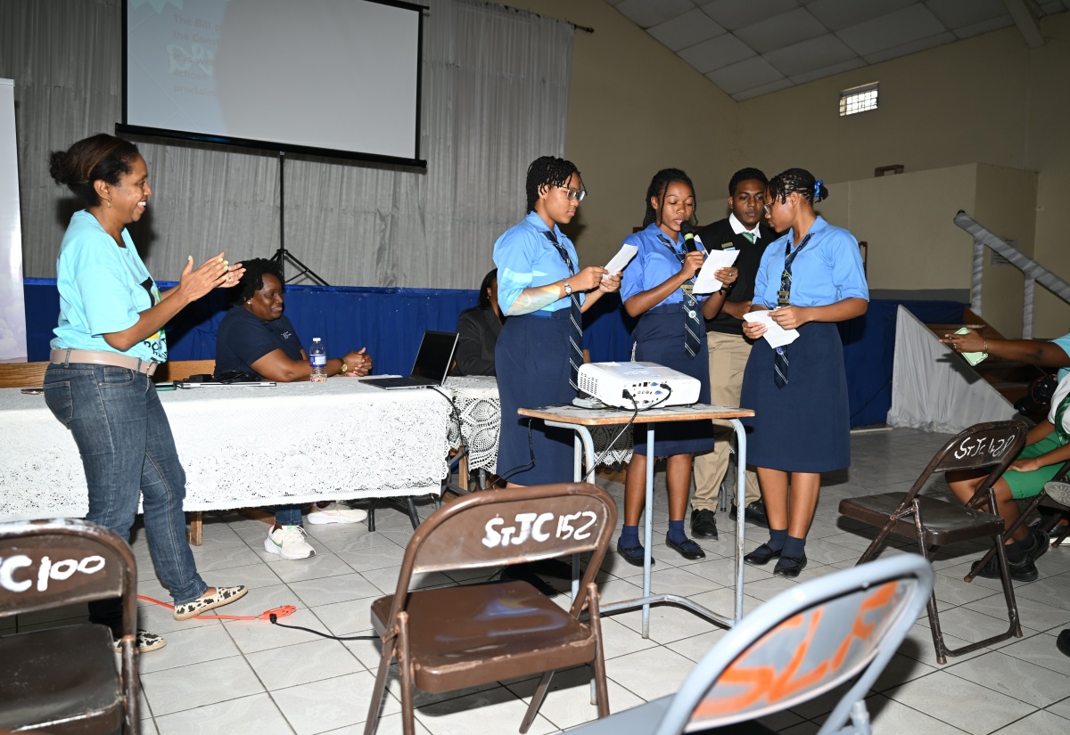 Director, Legal Education Division, Ministry of Legal and Constitutional Affairs (MLCA), Janelle Miller-Williams (left), applauds the presentation from Manning’s School students during the Ministry’s Road to Republic School Engagement Session held at the Sean Lavery Hall in Savanna-la-Mar on Thursday (Jan. 23).