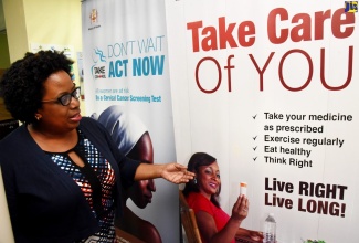 Director of Non-Communicable Diseases and Injuries Prevention, Ministry of Health and Wellness, Dr. Tamu Davidson, points to a health promotion flyer during a recent interview with JIS News at her New Kingston offices.