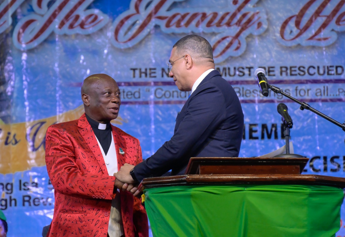 Prime Minister, Dr. the Most Hon. Andrew Holness  (right), greets Chief Coordinator and Founder, Power of Faith Ministries International Inc., Bishop Dr. Delford Davis, at the fifth staging of the National Day of Prayer and the 19th staging of the Heal the Family, Heal the Nation annual gathering, at the National Arena in Kingston, on January 8.

