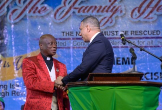 Prime Minister, Dr. the Most Hon. Andrew Holness  (right), greets Chief Coordinator and Founder, Power of Faith Ministries International Inc., Bishop Dr. Delford Davis, at the fifth staging of the National Day of Prayer and the 19th staging of the Heal the Family, Heal the Nation annual gathering, at the National Arena in Kingston, on January 8.

