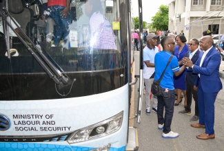 Minister of Labour and Social Security, Hon. Pearnel Charles Jr. (right), State Minister, Dr. the Hon. Norman Dunn (second right), and acting Permanent Secretary in the Ministry, Dione Jennings (third right), bid farewell to 96 farmworkers who departed Jamaica for Canada, on Friday (January 3), under the Seasonal Agricultural Workers Programme (SAWP). The occasion was a send-off ceremony, held at the Ministry’s Overseas Employment Centre, in Kingston.