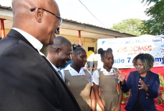 Minister of Education, Skills, Youth and Information, Senator Dr. the Hon. Dana Morris Dixon (right), converses with (from left) Roman Catholic Archbishop of Kingston, the Most Rev. Kenneth Richards; Principal of Holy Trinity High School, Father Carl Clarke; and students, Dasha Thompson and Dior Powell. The occasion was the launch of the Grade 7 Academy at the Kingston-based institution on Thursday (January 23). 